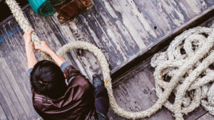 young-man-pulling-hard-on-rope